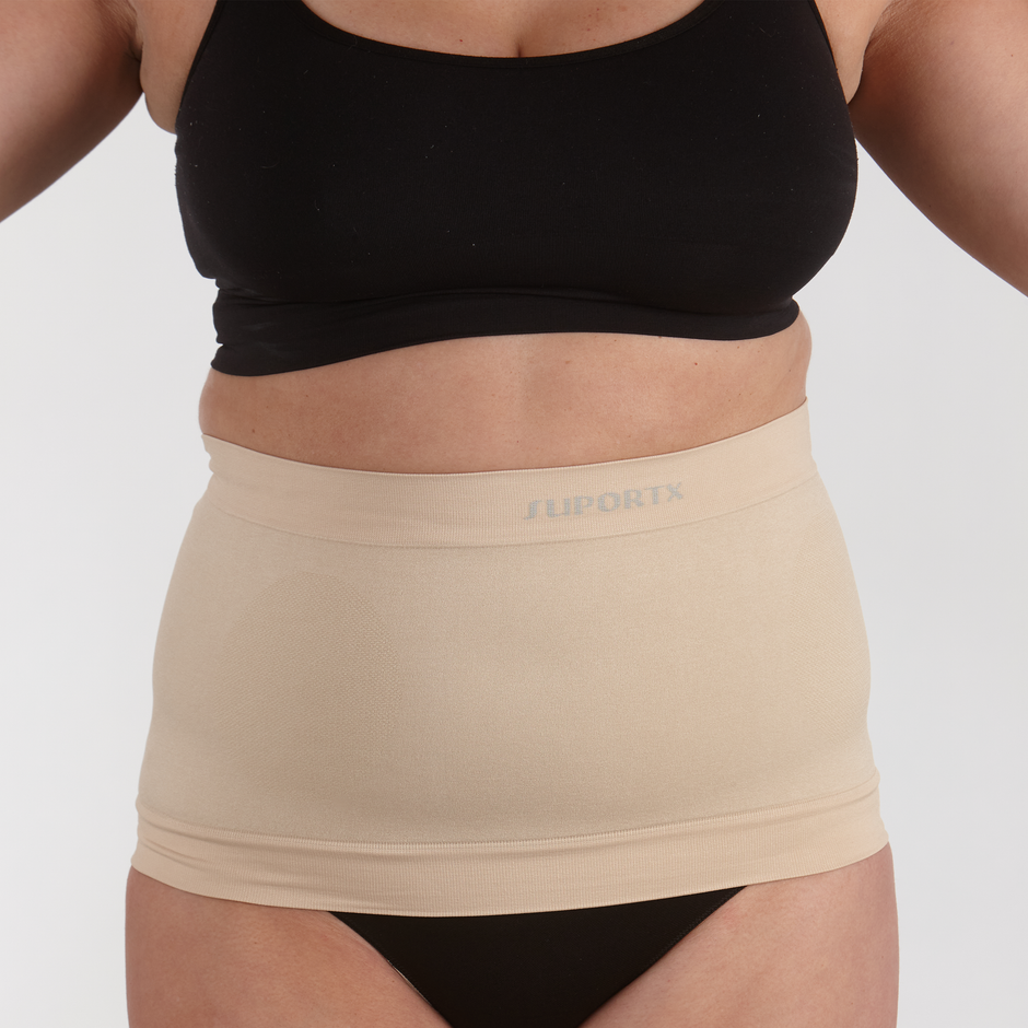 Model wearing a Suportx Stoma Secure ostomy belt in the beige color.