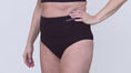 Load and play video in Gallery viewer, Video of a model wearing Suportx Breathable Briefs in black color. Show casing the ostomy underwear from left to right angle.
