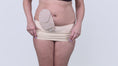 Load and play video in Gallery viewer, Video of lady wearing the Suportx Stoma Secure ostomy belt on top of her ostomy pouch.
